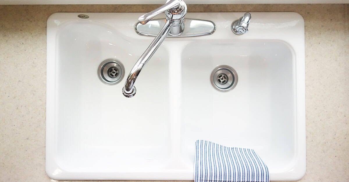 a clean shiny white enamel kitchen sink