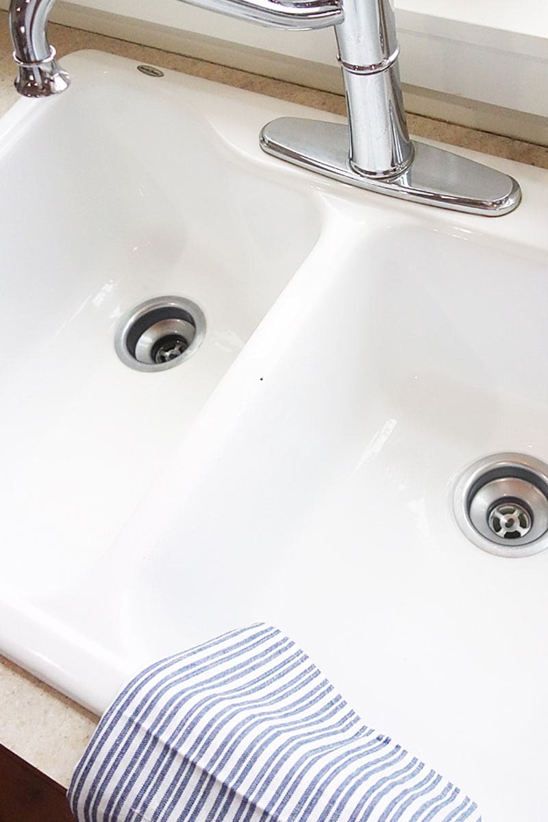 a clean shiny white enamel kitchen sink