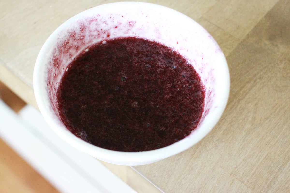 a little white bowl of jello mixture that has bloomed