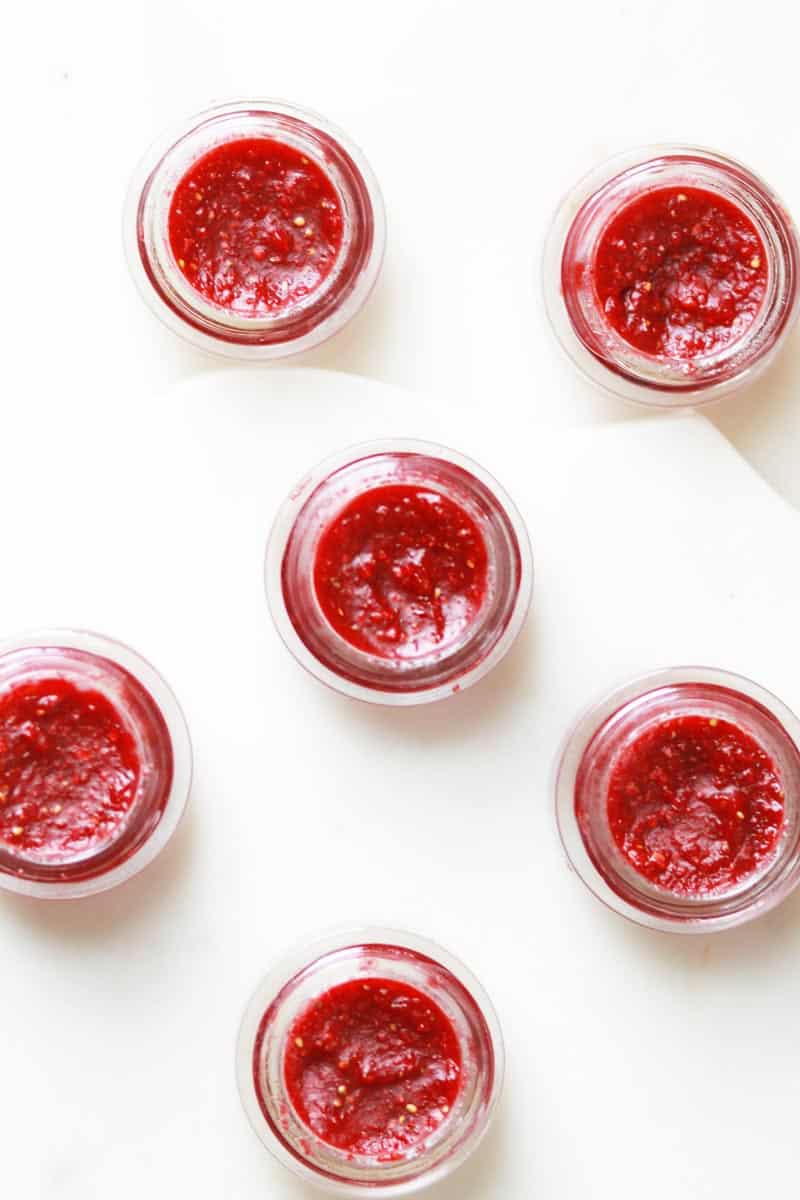 glass lip balm containers filled with homemade strawberry lip balm