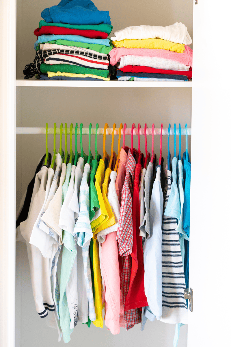 An organized kids closet with clothes stored neatly