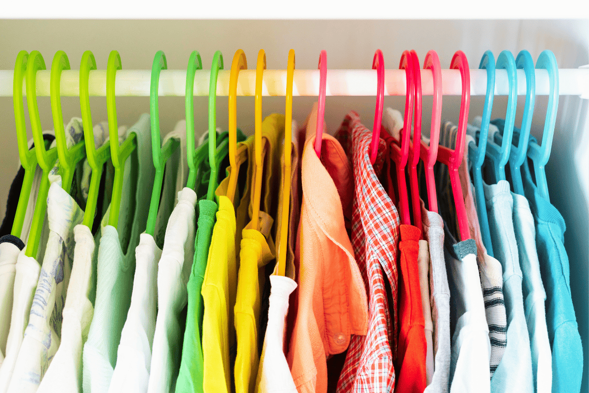 An organized kids closet with clothes stored neatly
