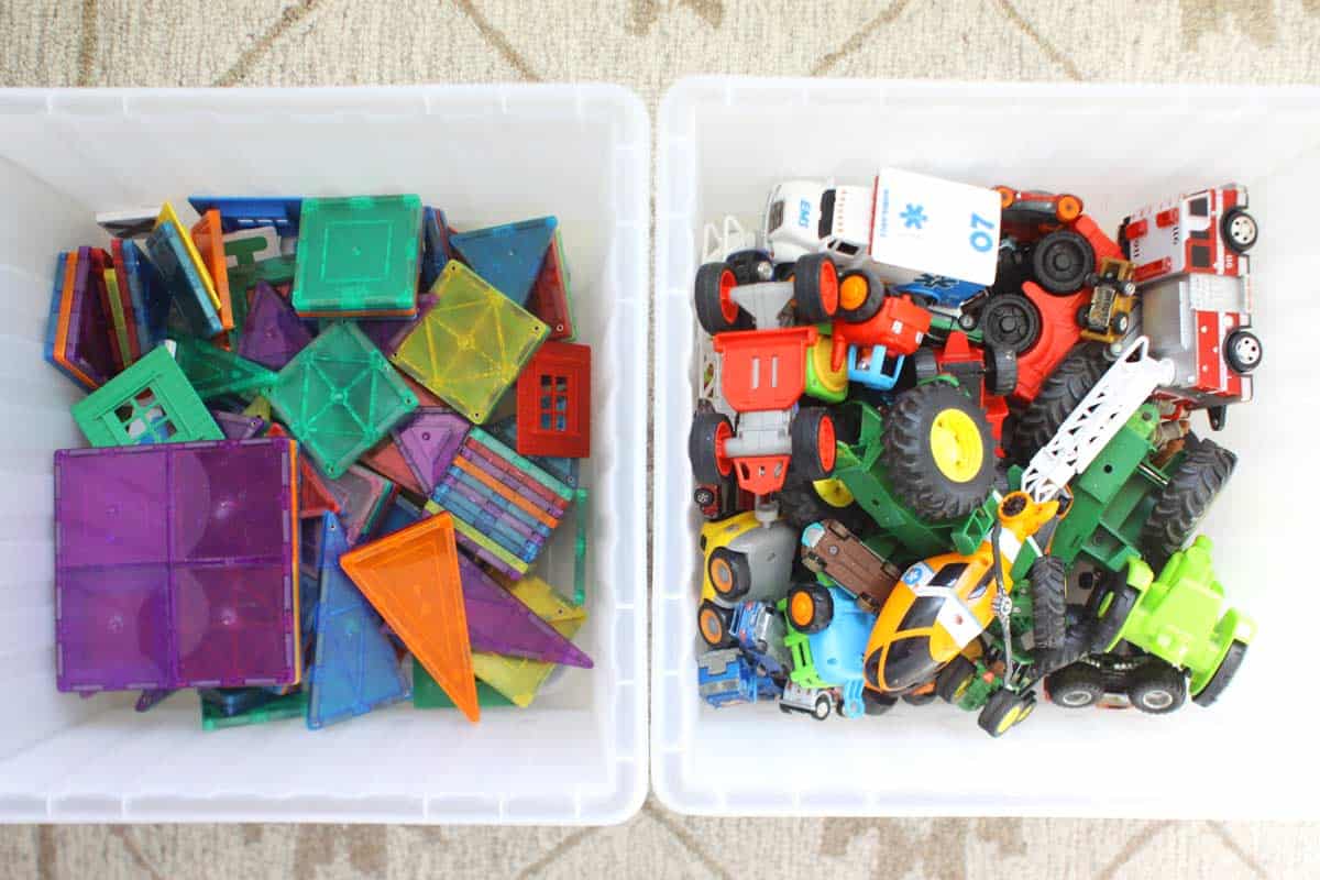 two clear plastic toys bins with sorted and organized toys in them