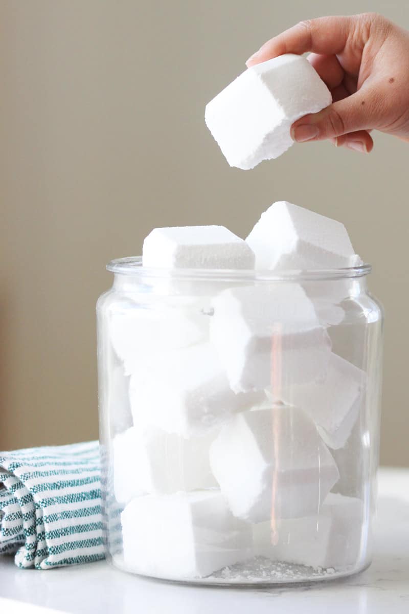 a glass canister full of toilet bowl cleaner tablets