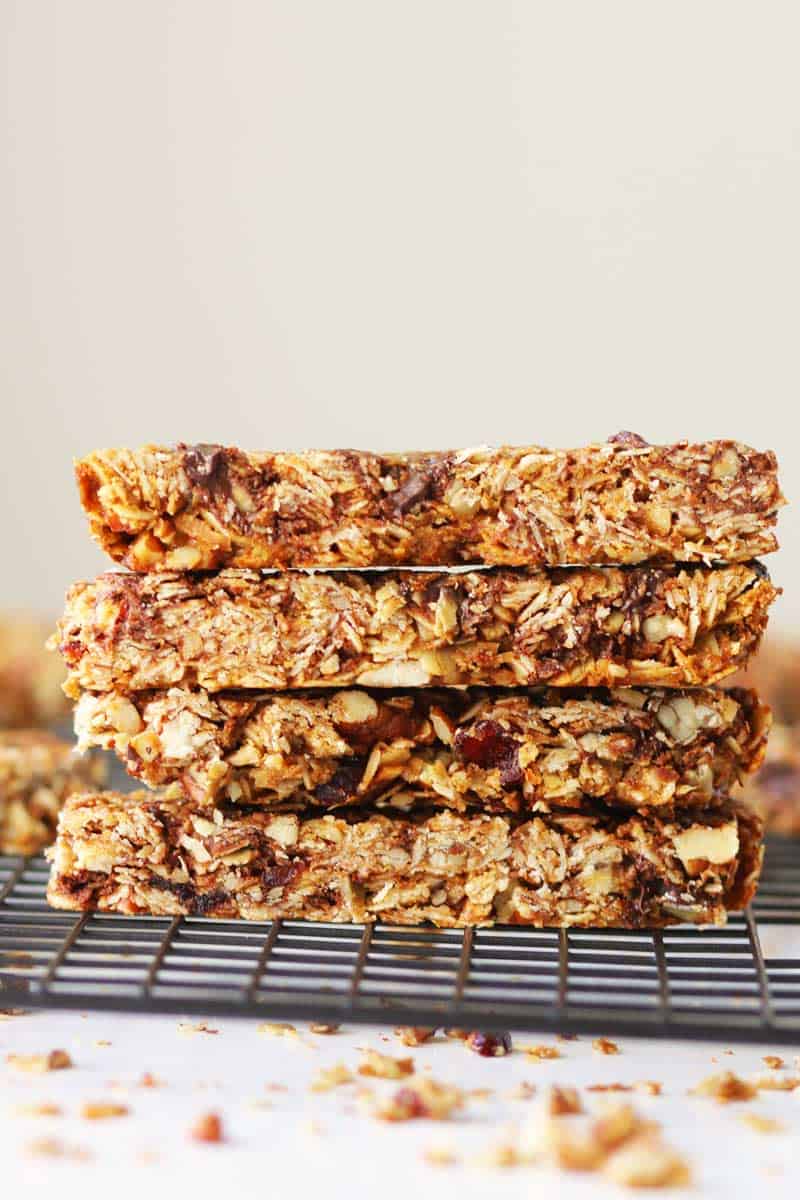 crunchy baked granola bars stacked on top of each other with craisins and chocolate chips in them