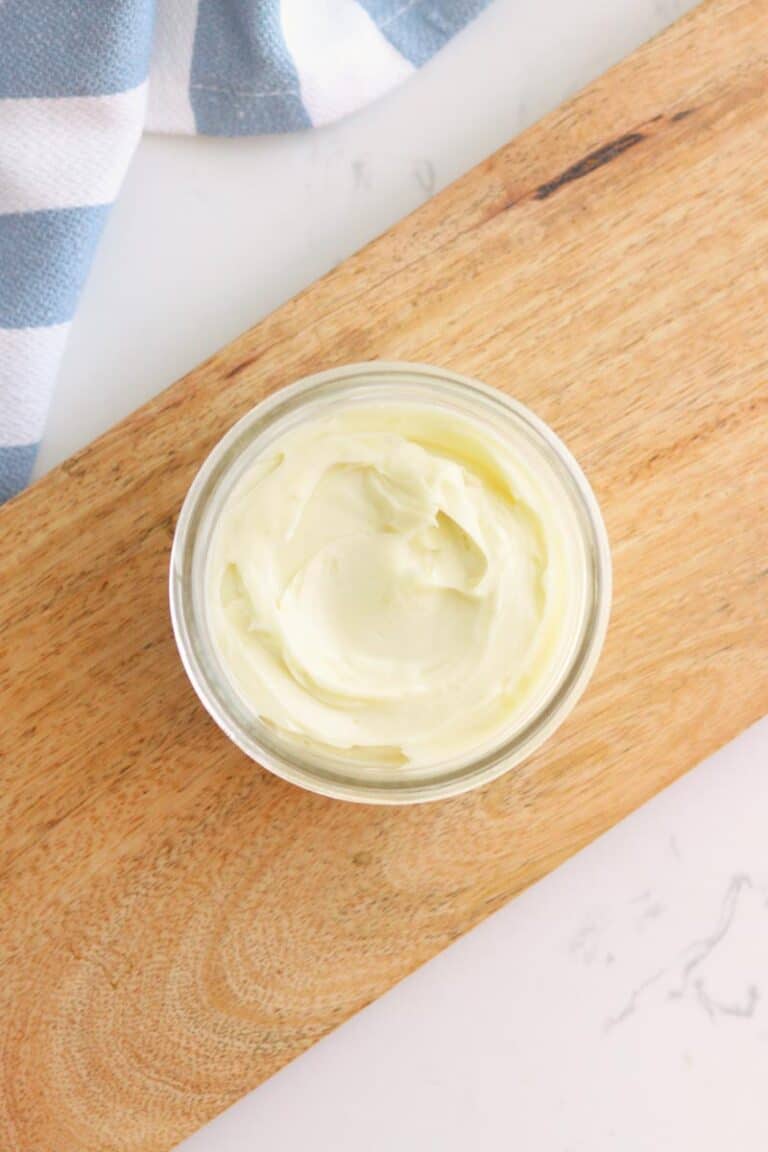 a small jar of whipped body butter on a wooden tray