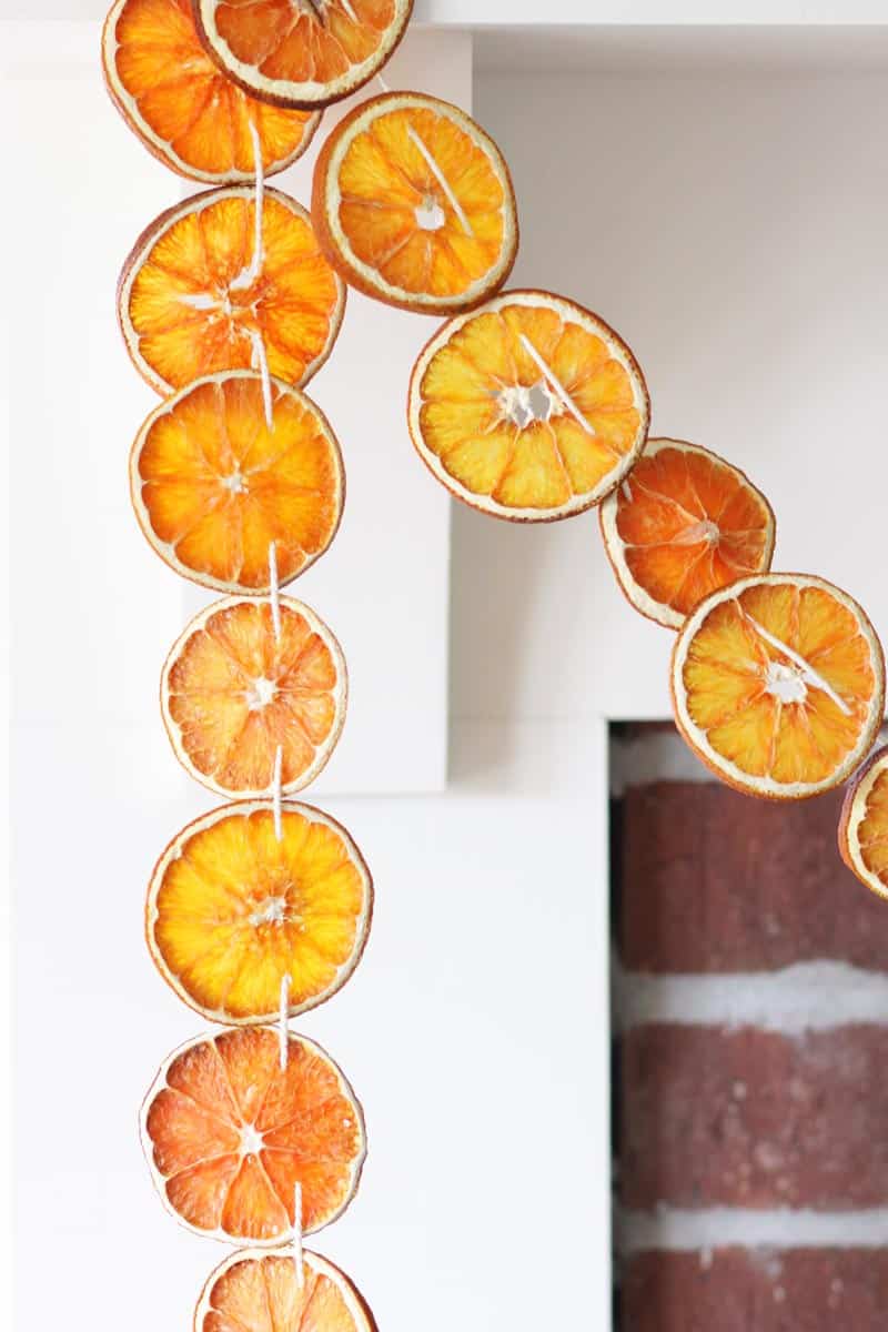 a dried orange slice garland hung on a mantle