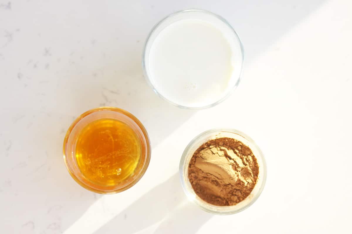 bowls of honey, cocoa powder and milk