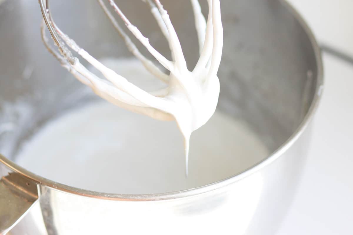 a mixer with a batch of homemade sunscreen whipped up in the bowl