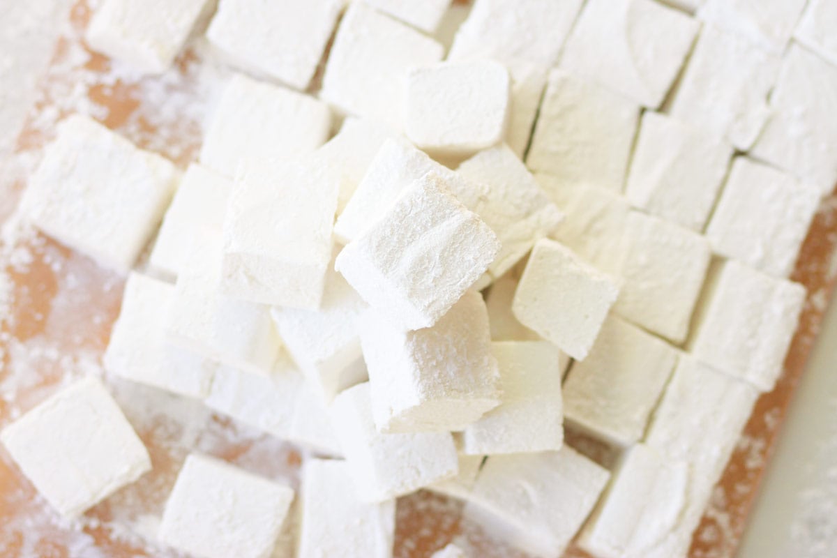 homemade marshmallows in a pile on a cutting board